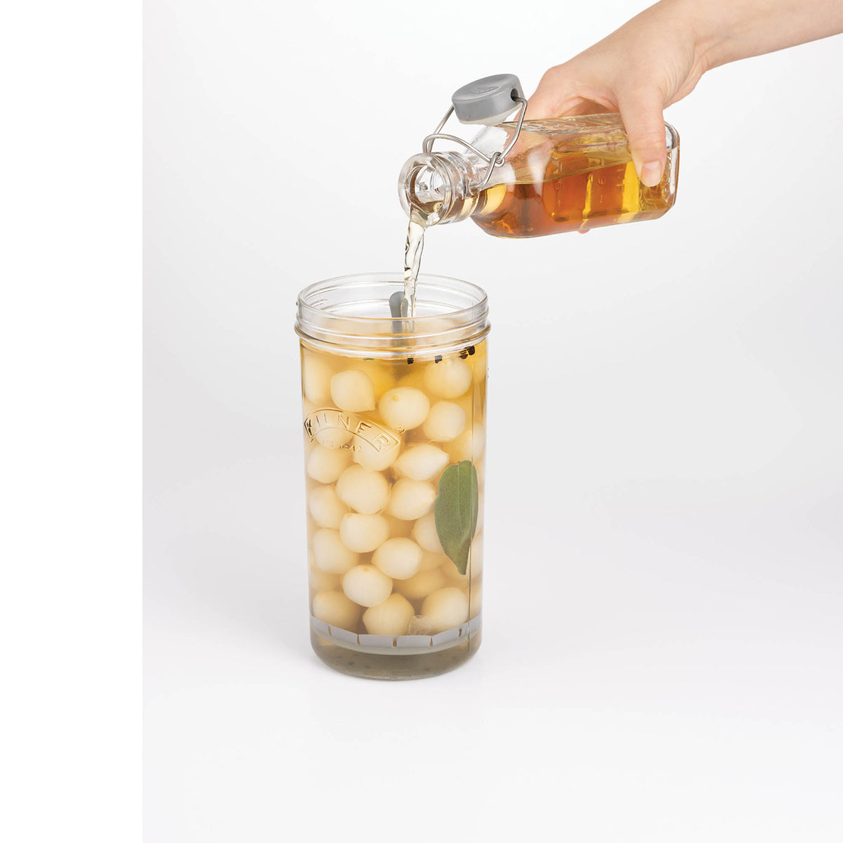 KILNER clear wide-mouth canning jar with metal lid for preserving and storing food, shown in a close-up view.