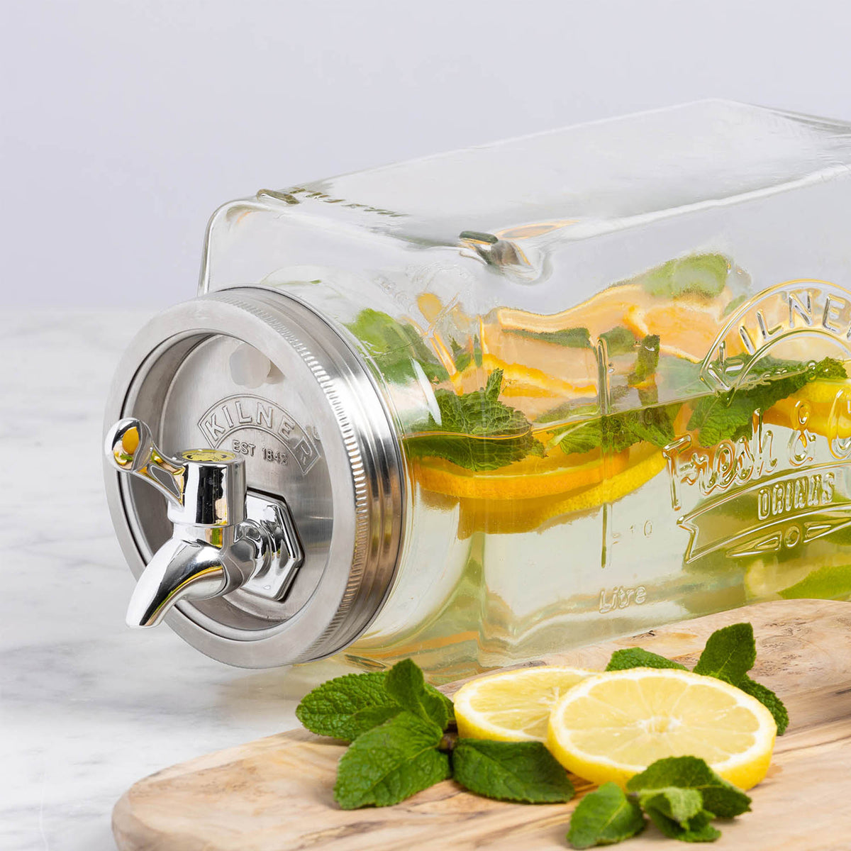 KILNER 3L clear glass drink dispenser with silver spigot and lid, designed for fridge storage of beverages.