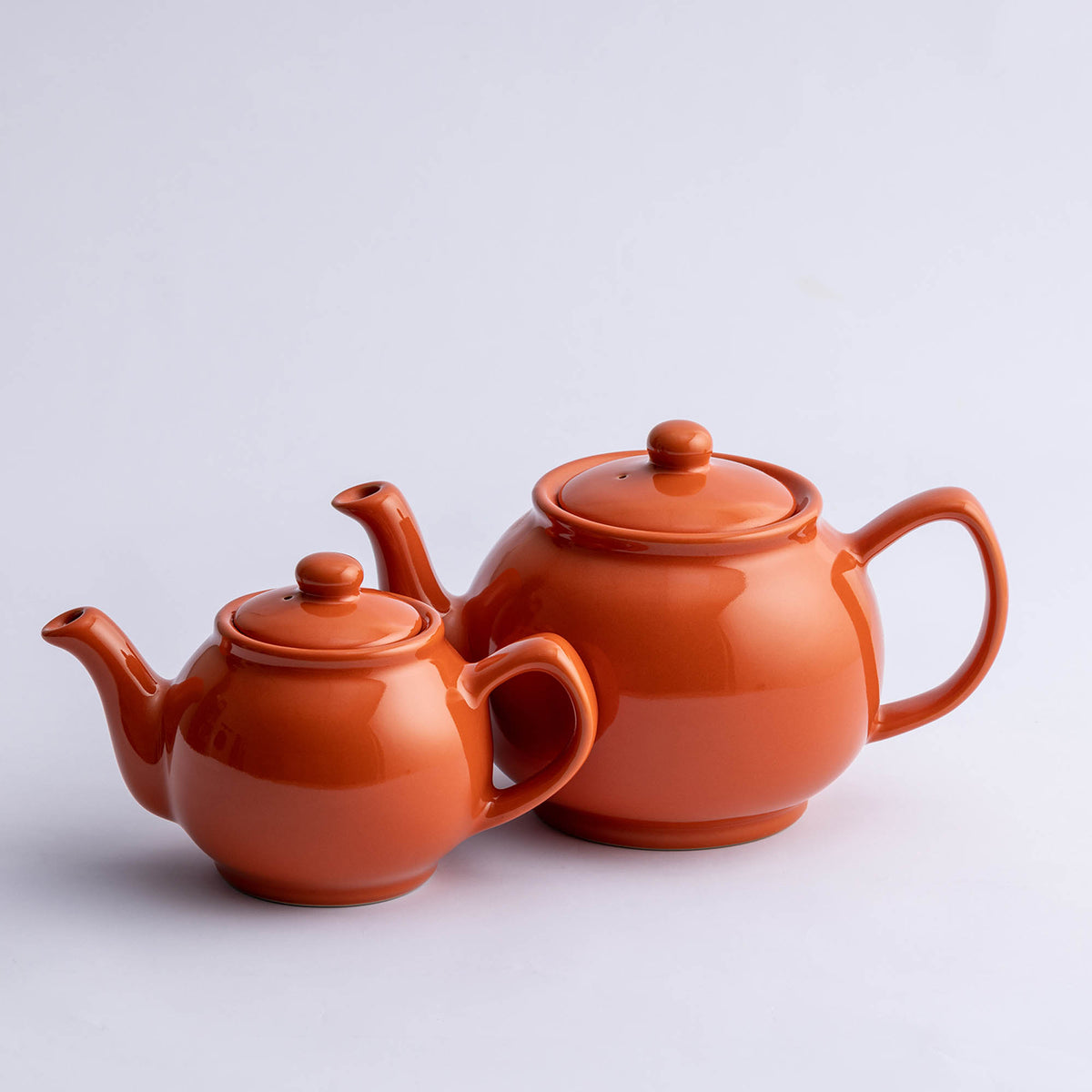 P & K Teekanne orange-themed tea pot with a vibrant orange and white design, ideal for brewing and serving tea.