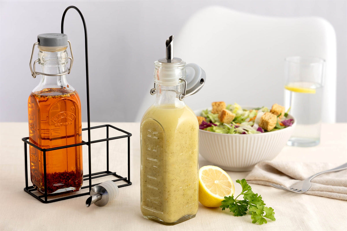 Clear KILNER oil and vinegar bottles with glass stoppers, ideal for stylish kitchen storage and condiment serving.