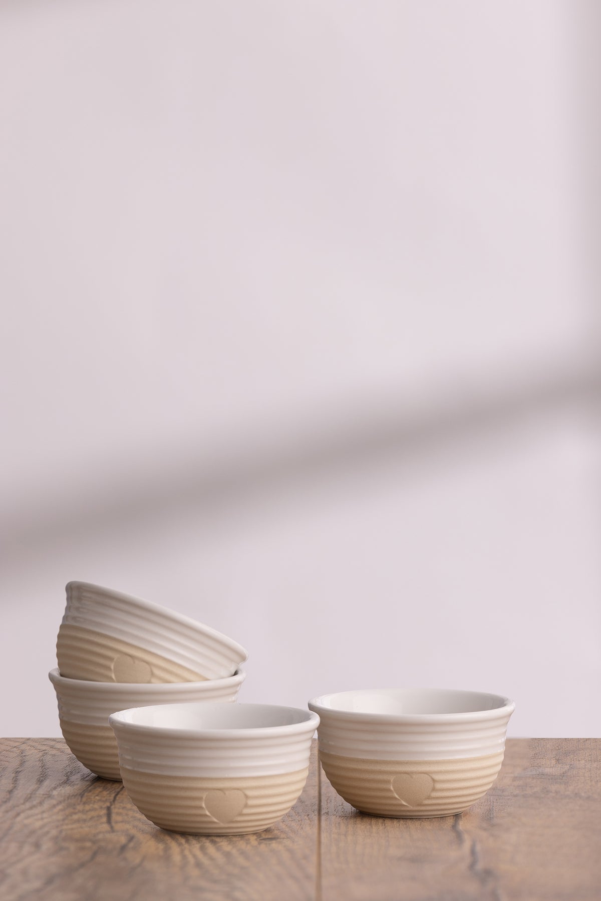 Set of four beige Mason Cash Rustic Charm bowls with a rustic, textured finish for kitchen or serving use.