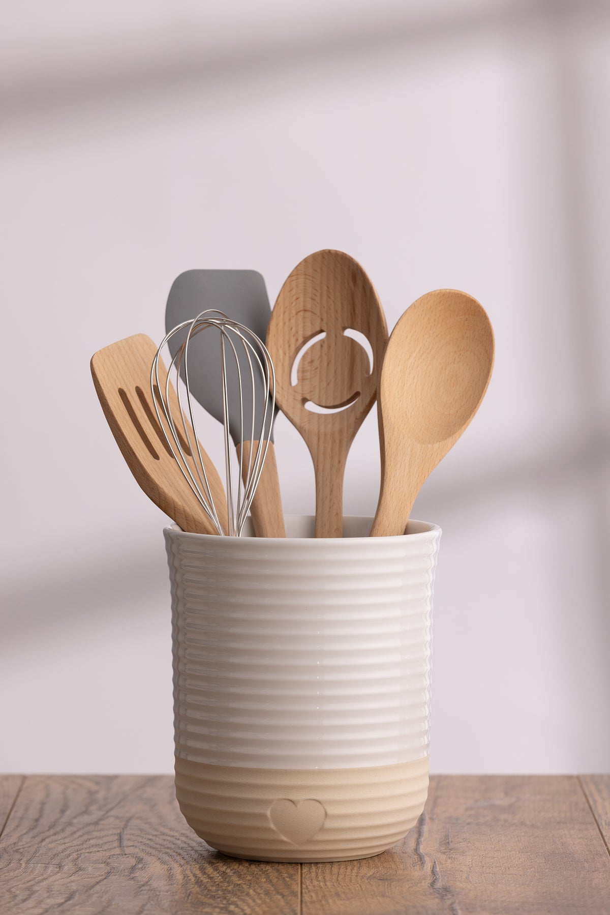 Mason Cash Rustic Charm beige utensil holder with wooden spoon and spatula, ceramic kitchen storage container.