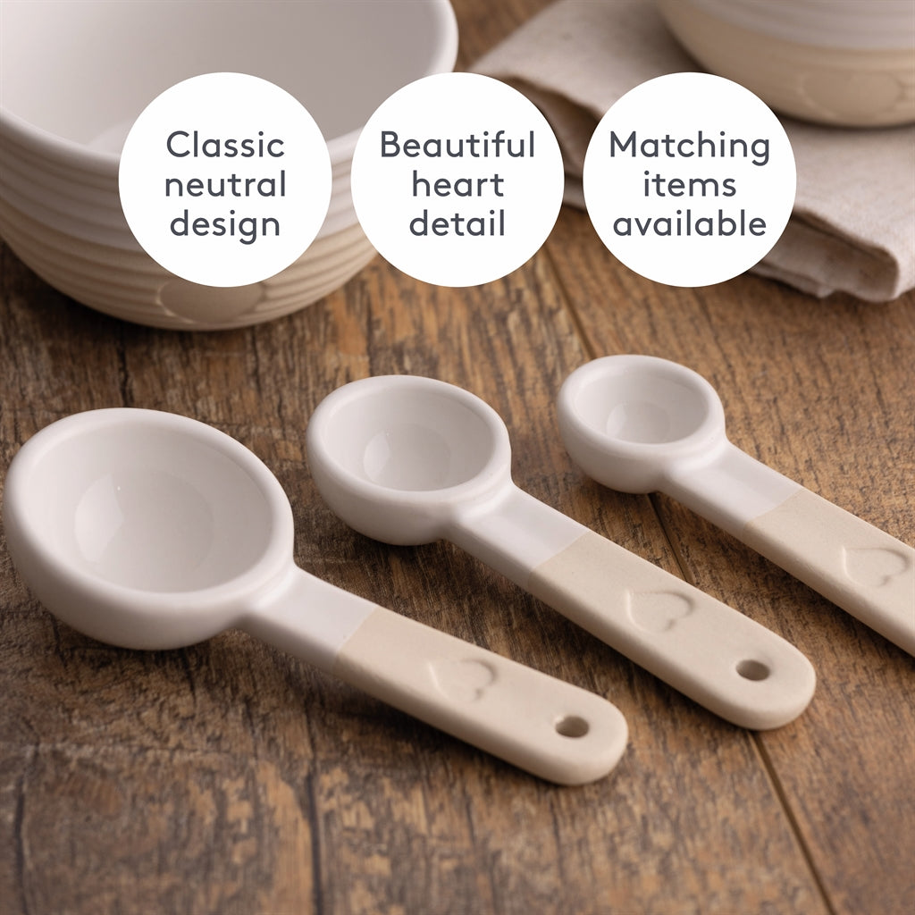 Set of three beige Mason Cash rustic charm measuring spoons, with long handles and engraved size markings.