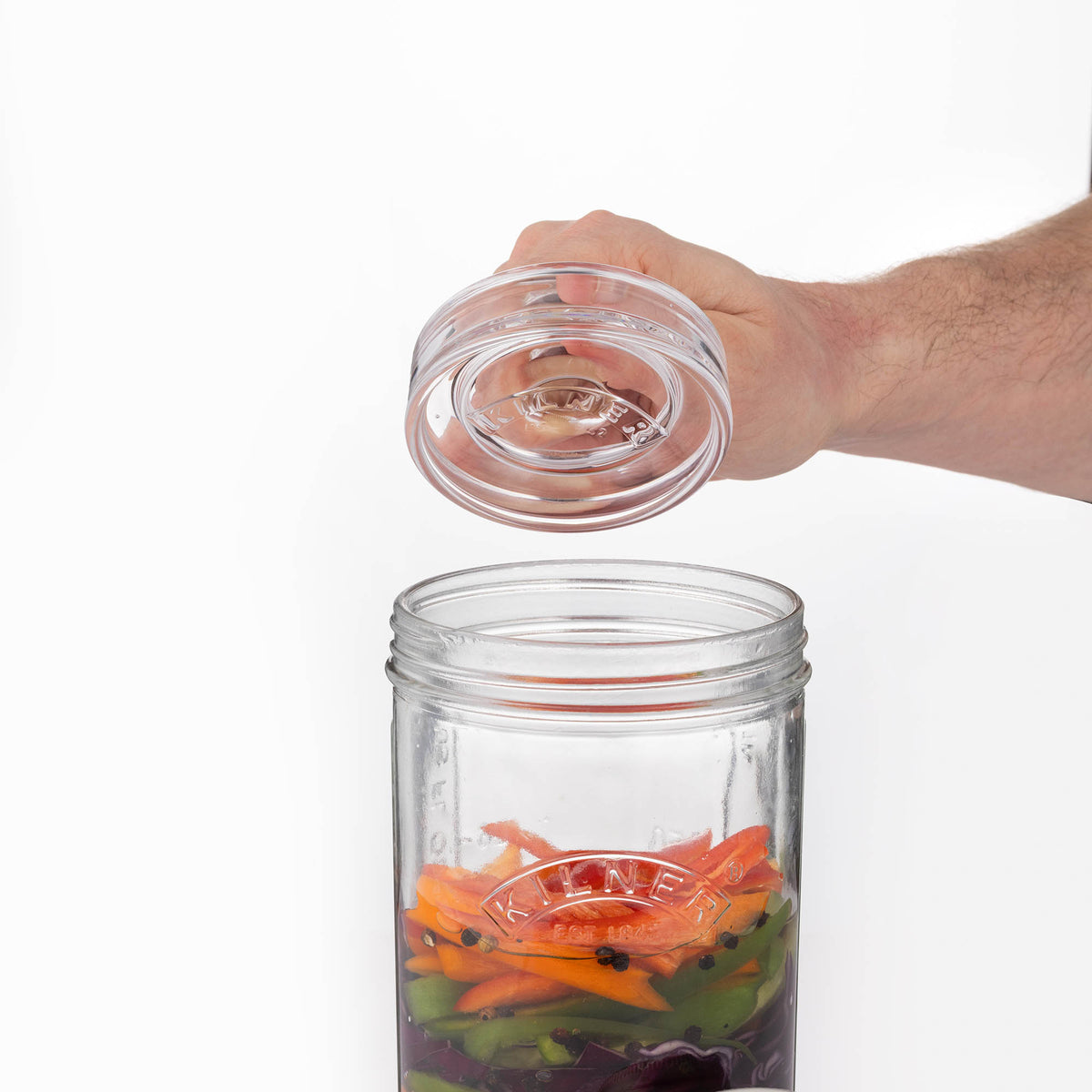 Clear KILNER fermenting weights used to keep ingredients submerged during fermentation processes.