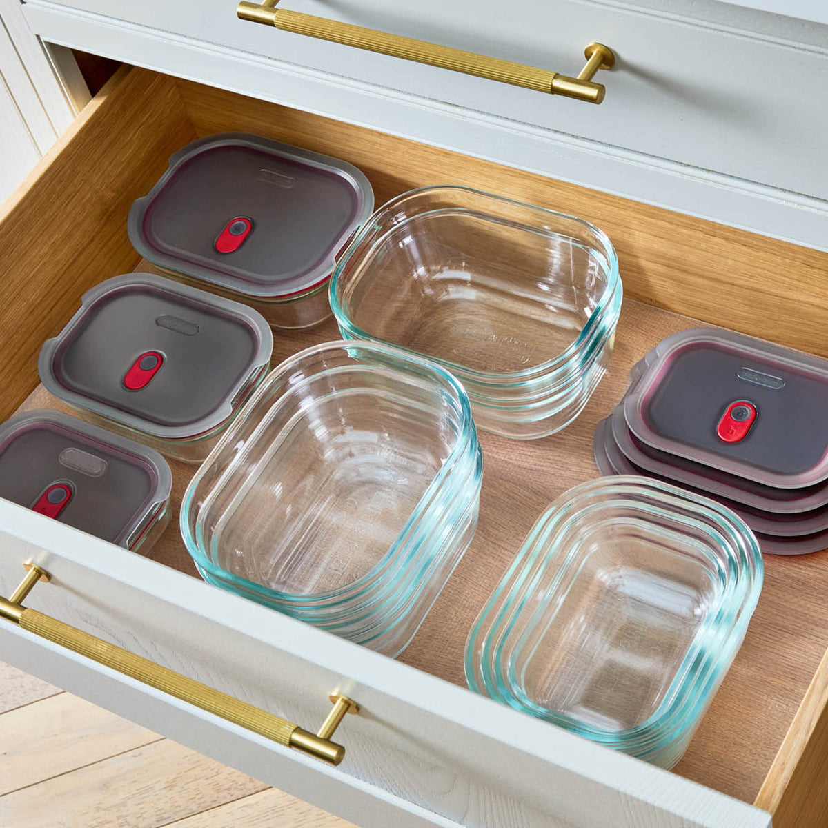 Set of four BLACK+BLUM multifunctional glass storage tins with clear lids, ideal for kitchen organization and food storage.