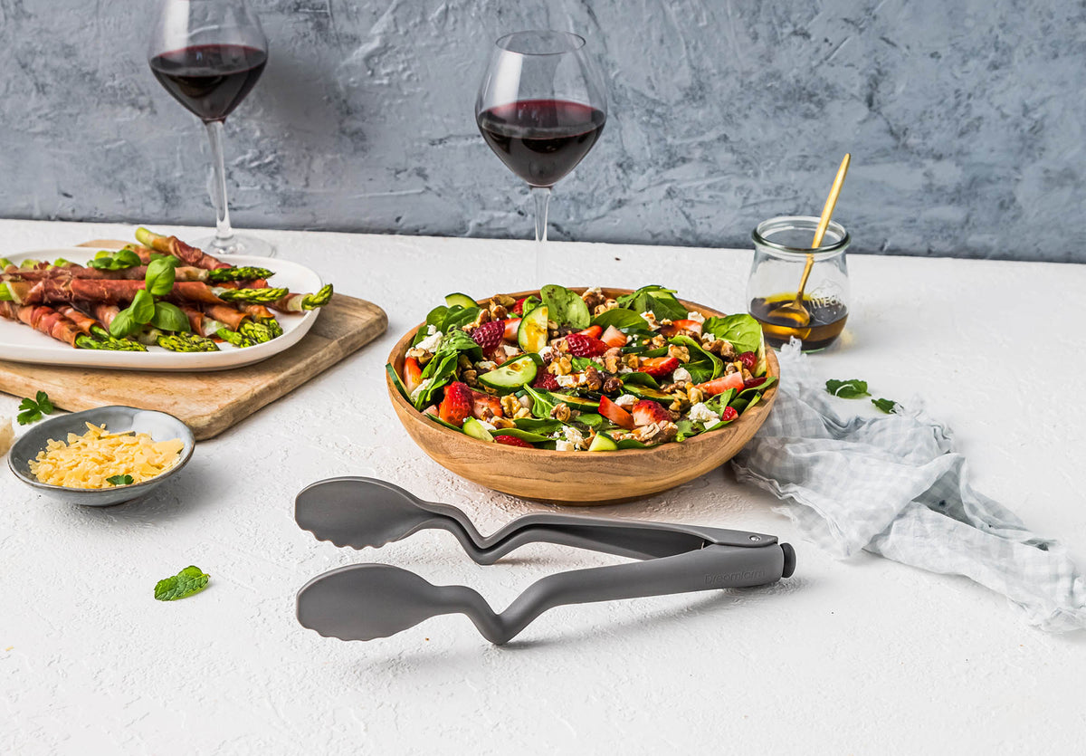 Black DREAMFARM Küchenzange with CLONGS handle, stainless steel tongs for cooking and serving.