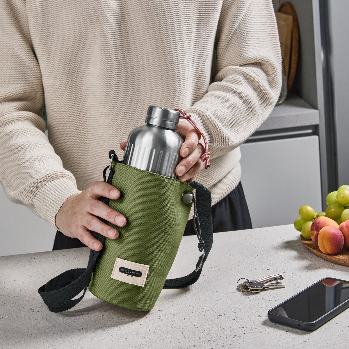 Black+Blum bottle bag for carrying explorer bottles, featuring a sleek black design and durable material for outdoor use.