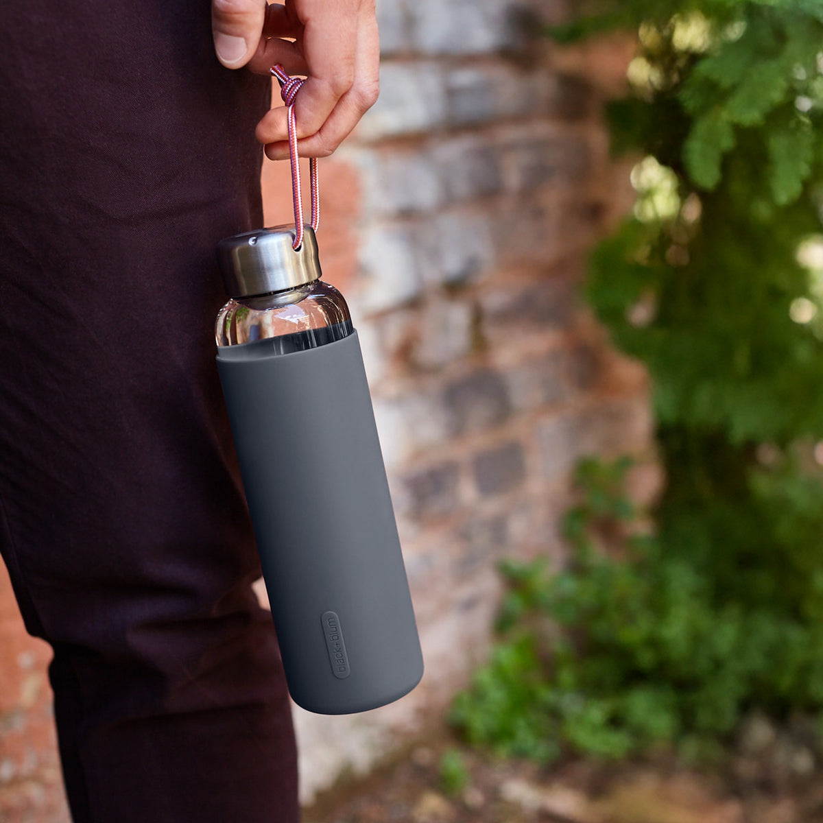 BLACK+BLUM TO-GO GLAS water bottle in ocean blue, 600ml, with sleek glass design and black lid for on-the-go hydration.
