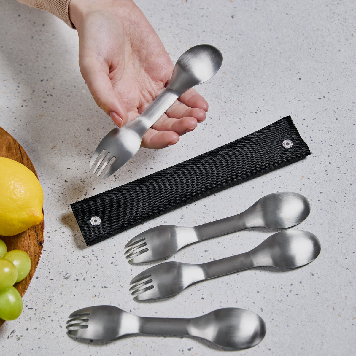 Set of four BLACK+BLUM Göffel stainless steel sporks in a case, ideal for to-go lunch and outdoor dining.