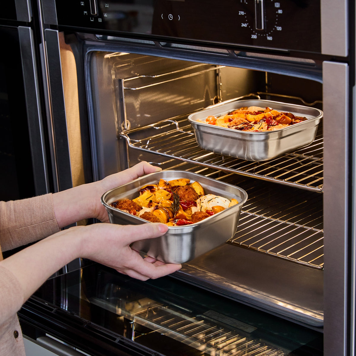 BLACK+BLUM stainless steel multifunction storage container with a square shape and oven-safe design.