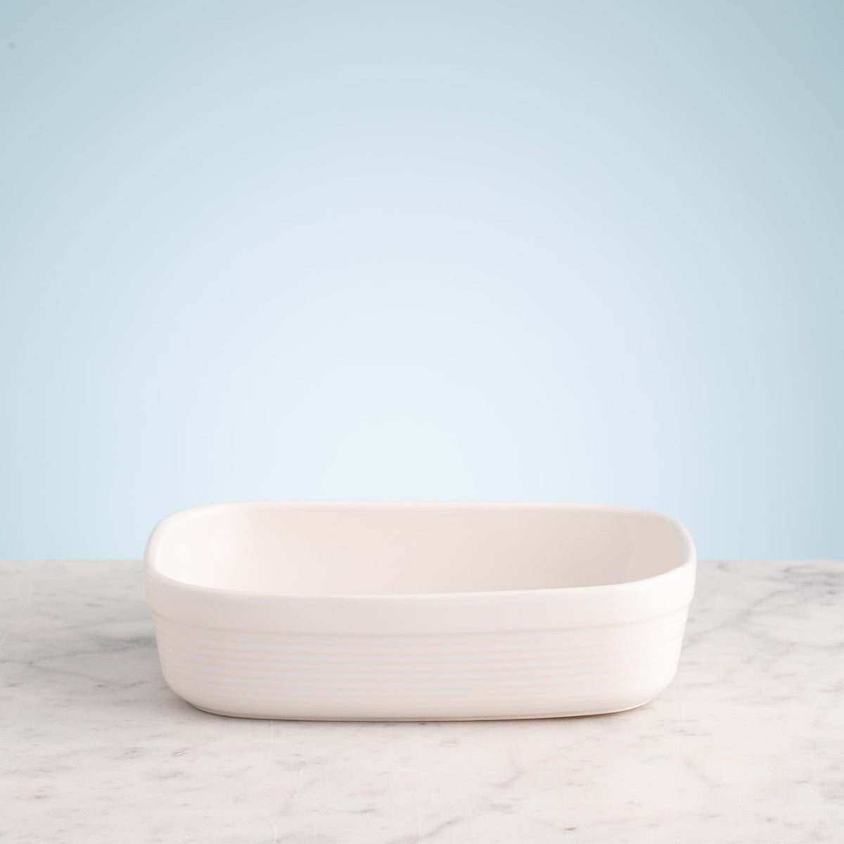 Gray rectangular Mason Cash baking dish with 1.4L capacity, showing slight glaze imperfections inside.