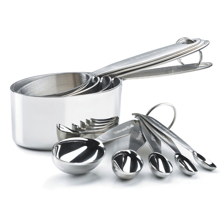 CUISIPRO 5-piece set of silver measuring spoons with 0.625 and 1.25 capacity, used for precise cooking and baking.