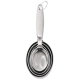 CUISIPRO stainless steel measuring cups set with four graduated beakers, silver color, for accurate kitchen measurements.