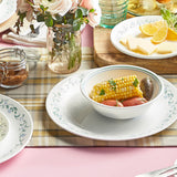 Corelle Country Cottage white dinnerware set with floral graphic design, featuring plates and bowls for everyday use.