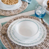 Corelle Country Cottage white dinnerware set with floral graphic design, showcasing plates and bowls in a charming, rustic style.