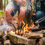 Lodge black fire and cook stand for grills, featuring a sturdy metal frame with a circular grate for outdoor cooking and grilling.