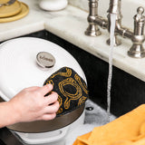 Black and yellow Lodge everyday scrub brush with stiff bristles, designed for cleaning and scrubbing surfaces.