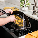Lodge everyday scrub brush with black and yellow bristles, durable plastic handle, suitable for cleaning tasks.