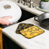 LODGE everyday scrub brush in black and yellow with sturdy bristles, ideal for cleaning and scrubbing tasks.
