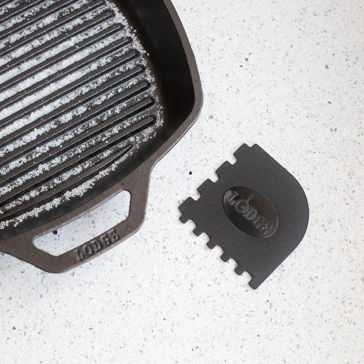 Lodge black and red grill pan scrapers, 2-piece set, with metal handles for easy cleaning of cast iron grill pans.