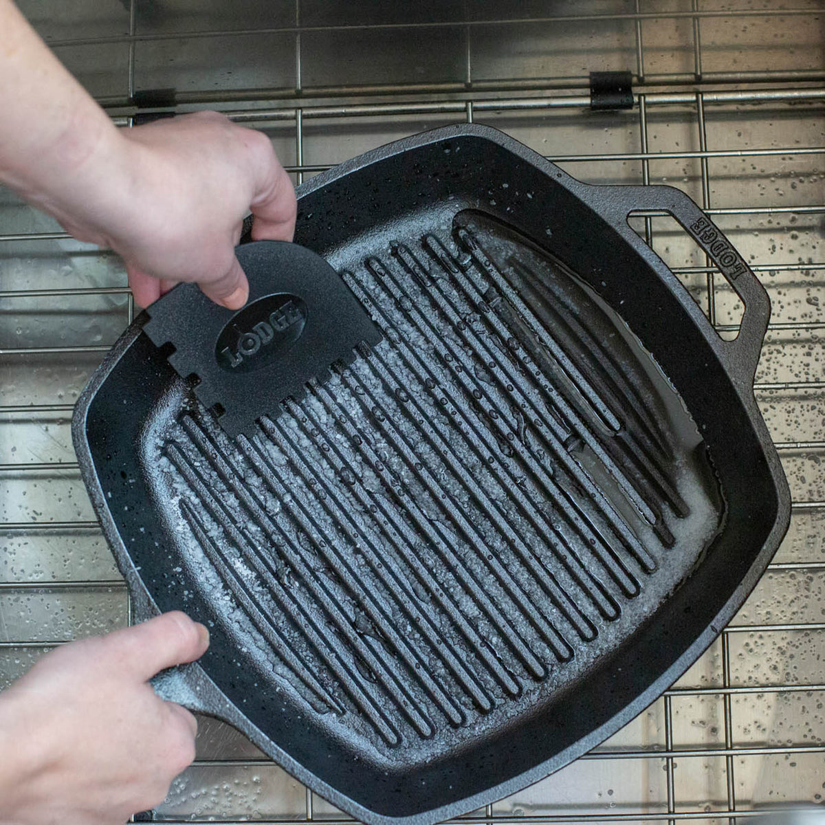 Lodge black and red grill pan scrapers, 2-piece set, durable silicone spatulas for non-stick grill cookware.