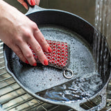 LODGE silicone and steel scrub pad in red, durable kitchen cleaning tool for cookware and surfaces.
