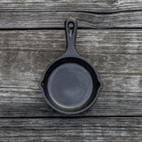 Lodge classic black cast iron skillet with handle, perfect for cooking and frying on stovetop or oven.
