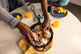 Lodge classic black cast iron skillet shown with a smooth cooking surface and sturdy handle.