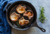Black LODGE cast iron skillet, classic design, showing the smooth cooking surface and sturdy handle.