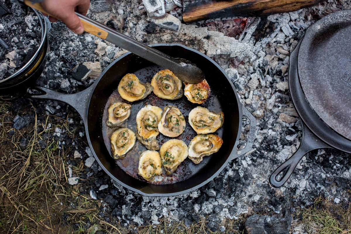 Black Lodge Classic cast iron skillet with wooden handle, showing smooth cooking surface and sturdy construction.