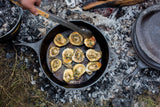 Black Lodge Classic cast iron skillet with wooden handle, showing smooth cooking surface and sturdy construction.