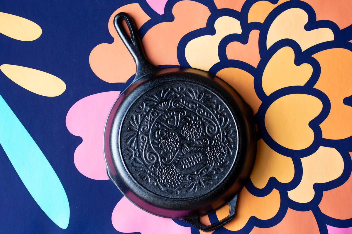 Lodge Classic black cast iron skillet with handle, suitable for stovetop and oven cooking, shown from a side view.