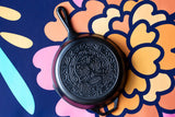 Lodge Classic black cast iron skillet with handle, suitable for stovetop and oven cooking, shown from a side view.
