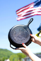 Lodge cast iron skillet with US flag design, 25.4 cm, black pan suitable for cooking and frying.