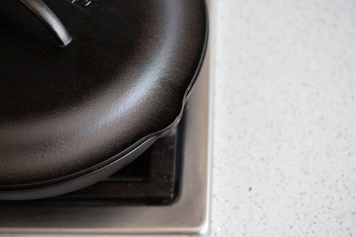 Black Lodge Classic lid for cookware, featuring a sturdy handle and snug fit, designed for optimal heat retention and easy handling.