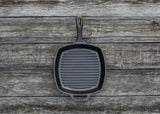 Lodge square cast iron grill pan in black with a 26.7 cm diameter, ideal for grilling and searing.