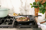 Lodge classic black square grill pan with a 26.7 cm diameter, cast iron construction, suitable for outdoor and indoor grilling.