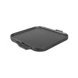Lodge Classic black two-sided flat and ridged grill plate for outdoor cooking, featuring a durable cast iron surface.