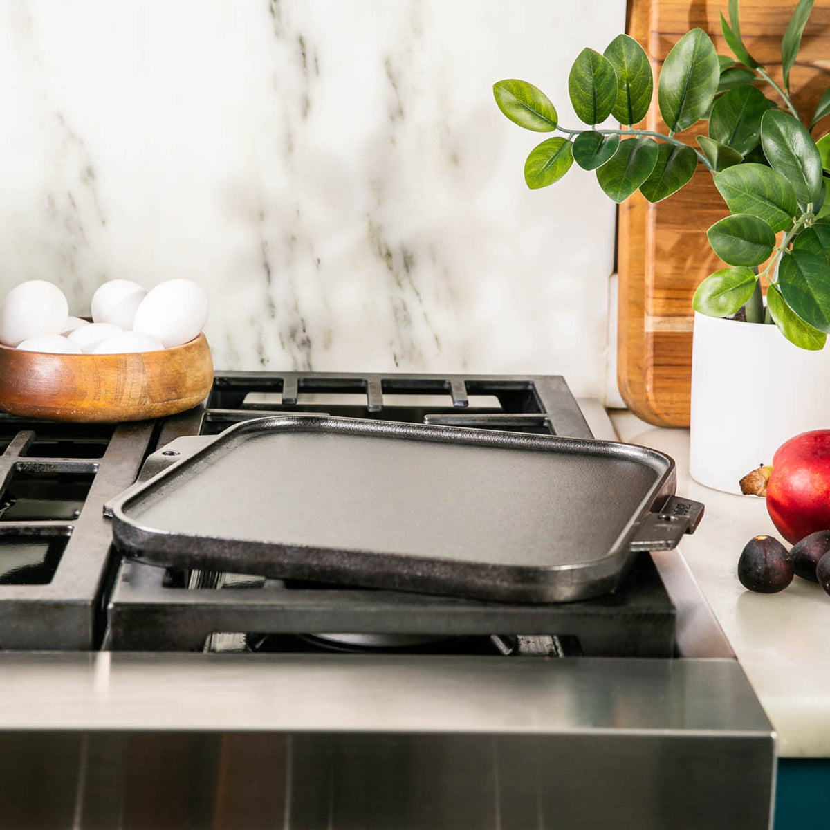 Lodge Classic black double-sided flat and ridged grill plate for versatile outdoor cooking.