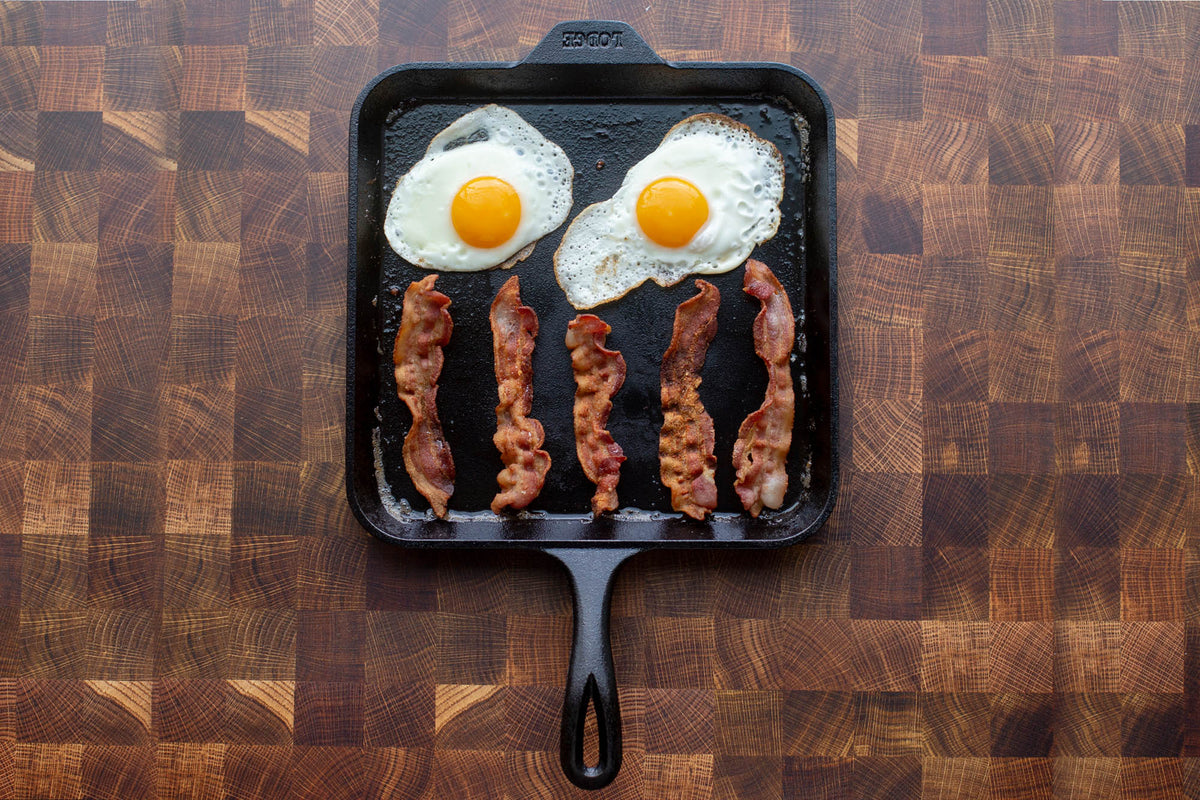 Square black Lodge Classic grill plate, 27.9 cm, durable cast iron cooking surface for outdoor grilling and searing.