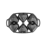 Lodge classic black heart-shaped cake pan with six cavities for baking cakes and desserts.