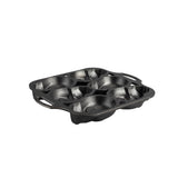 Lodge classic black cake mold with six skull-shaped cavities for creative baking and decorative desserts.