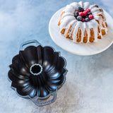 Lodge Classic black cake pan with a round shape and smooth edges, ideal for baking cakes and desserts.