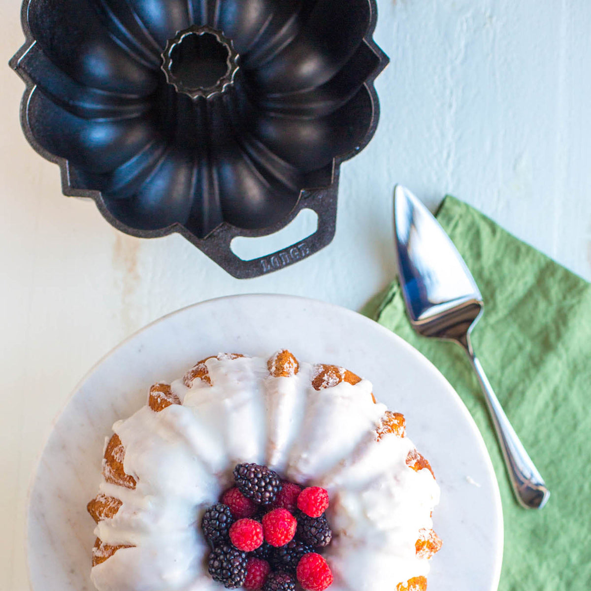 Black LODGE classic cake pan with a smooth, non-stick surface and sturdy metal construction for baking.