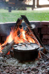 Lodge Classic black grill with a sturdy handle and cooking surface, designed for outdoor barbecues and grilling.