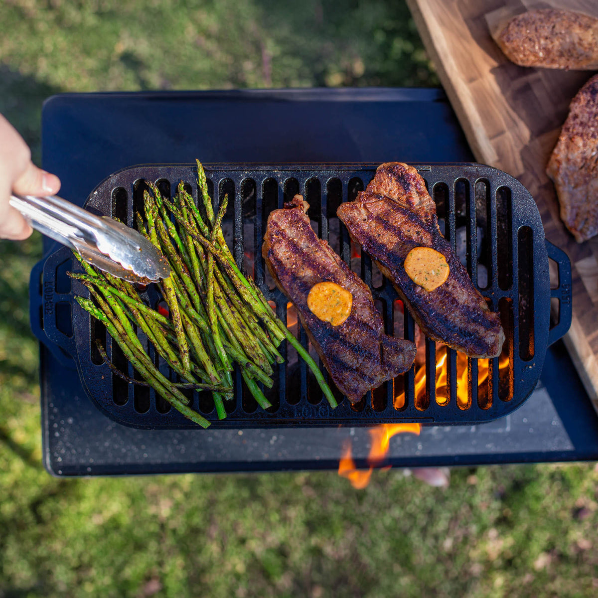 Black Lodge Sportsman’s Pro grill with sturdy construction, cooking surface, and control knobs for outdoor grilling.