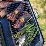 Lodge Sportsman’s Pro black cast iron grill with a sturdy handle and cooking surface for outdoor grilling.