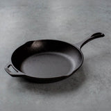 Lodge black cast iron pan, Chef series, showing a smooth cooking surface and sturdy handle for versatile kitchen use