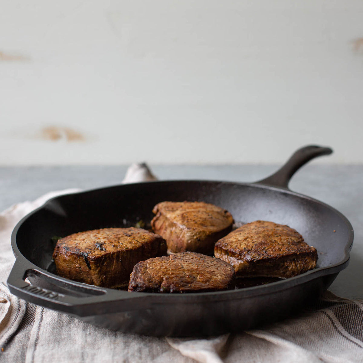 Black Lodge Chef cast iron skillet showing a sturdy, black cooking pan with a handle, suitable for versatile stovetop and oven use.