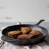 Black Lodge Chef cast iron skillet showing a sturdy, black cooking pan with a handle, suitable for versatile stovetop and oven use.